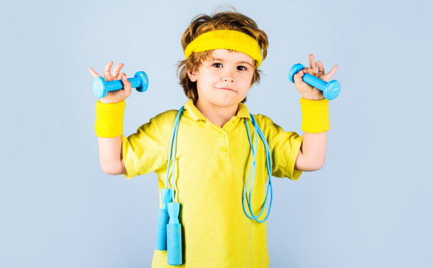 Boy with jumping rope and dumbbells. Fitness kid. Sport. Childhood activity. Child sportsman - Foto, imagen