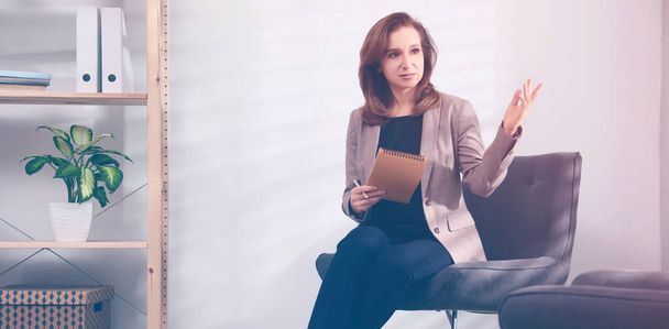 Portrait of psychotherapist with notebook in office. Banner design - Фото, изображение