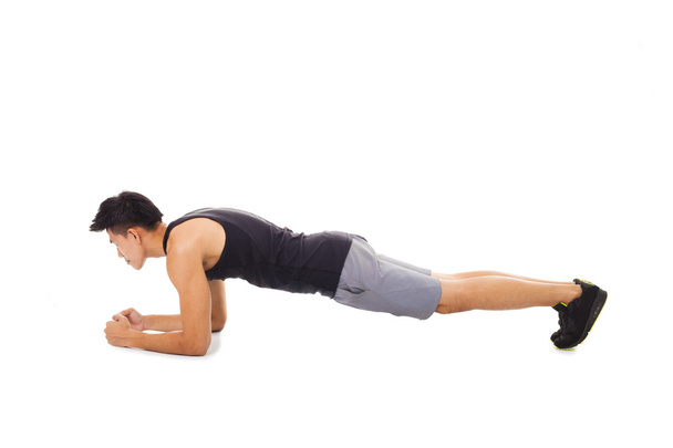 young fitness man doing plank core exercise working out  - Fotó, kép