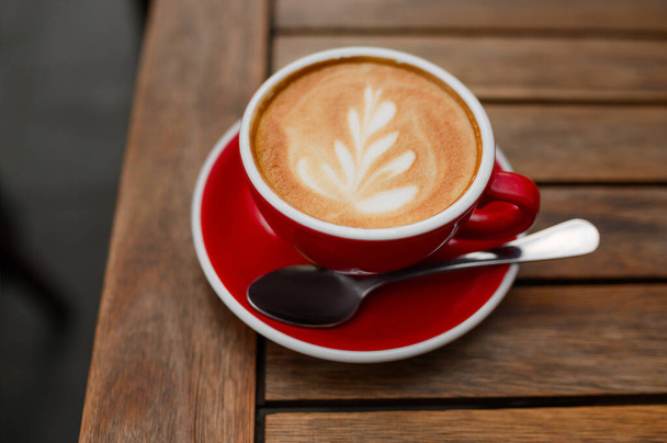 Cup of aromatic coffee on wooden table - Φωτογραφία, εικόνα