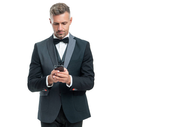 tux man messaging on smartphone isolated on white background. - Φωτογραφία, εικόνα