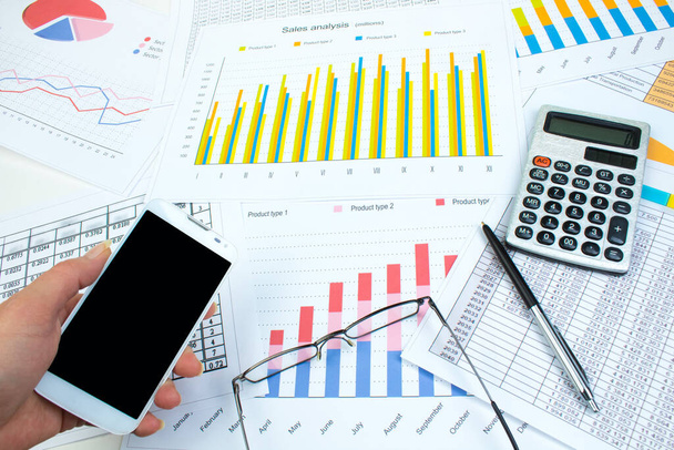 Financial printed paper charts, graphs and diagrams on the table - Foto, imagen