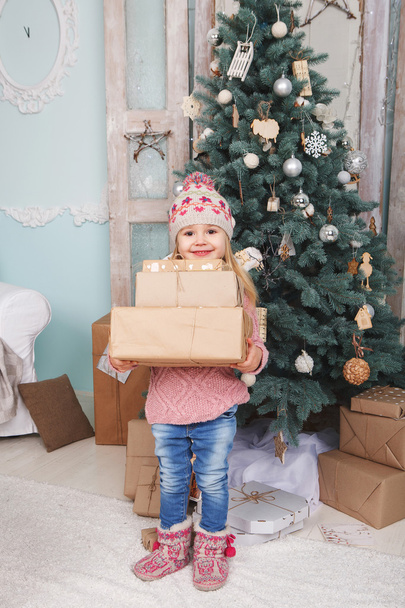 Little girl with new year gifts - Photo, Image