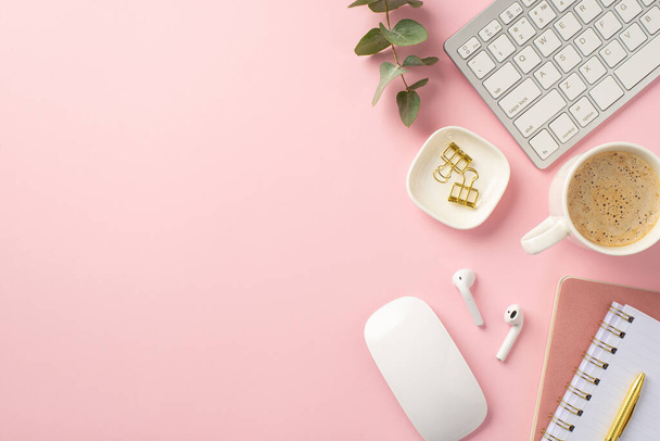 Business concept. Top view photo of workstation keyboard computer mouse cup of hot drinking wireless earbuds binder clips pen reminders eucalyptus leaves on isolated pink background with empty space - Foto, Imagen