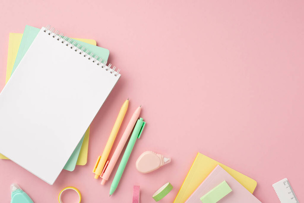 Back to school concept. Top view photo of colorful school supplies notepads pens round correction tape ruler and adhesive tape on isolated pink background with copyspace - Φωτογραφία, εικόνα