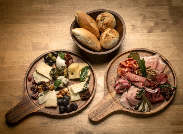 mixed european charcuterie and cheese cold cuts platter on wood table - Fotoğraf, Görsel
