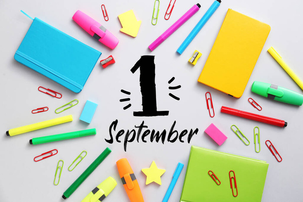 Bright school supplies and text 1 SEPTEMBER on light background - Photo, Image