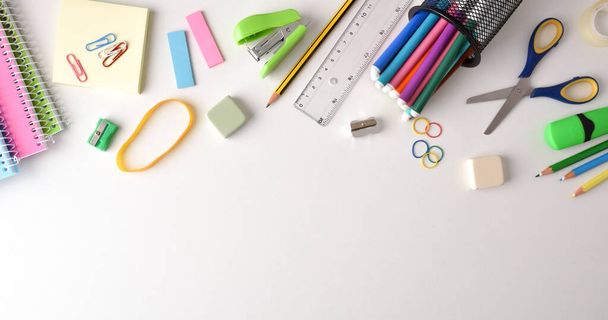 Background with school supplies on white table on top. Top view. Horizontal panoramic composition. - Fotografie, Obrázek