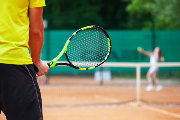 Midsection of male tennis player holding the racket in ready position. - Fotoğraf, Görsel
