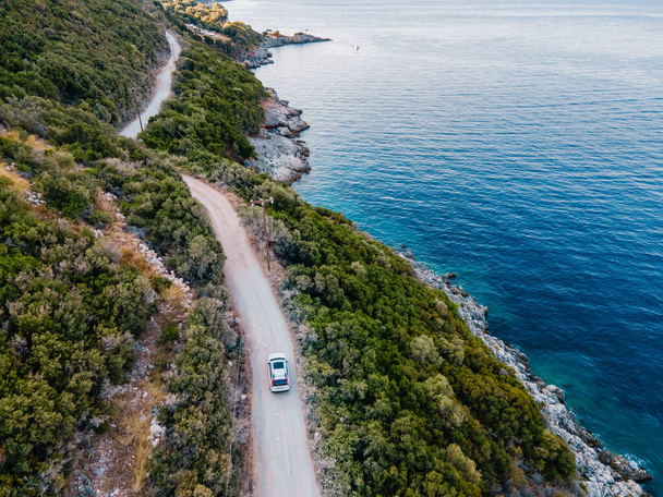 overhead view of car moving by road next to sea shore copy space - Photo, Image