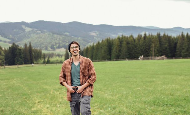 Egy fiatal srác egy kamerával utazik a hegyekben. - Fotó, kép