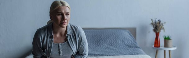 tired blonde woman with menopause in bedroom, banner - Φωτογραφία, εικόνα