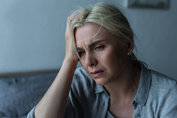 exhausted blonde woman having migraine during menopause  - Fotó, kép