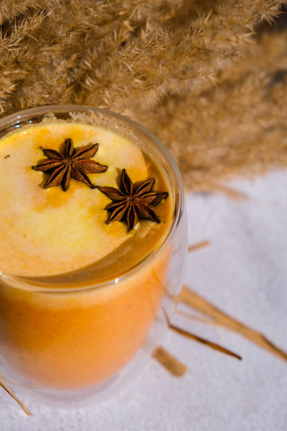 Pumpkin smoothie spiced latte. Anise stars. Autumn coffee with spicy pumpkin flavor seasonal hot drink. Fall Drinks for Halloween and Thanksgiving. Vegan healthy dieting food - Foto, Imagem