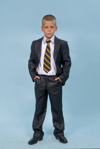young boy in suit with blue sky background - Fotó, kép