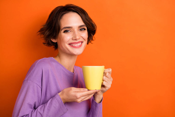 Photo of gorgeous friendly person hands hold fresh coffee cup isolated on orange color background. - Фото, зображення