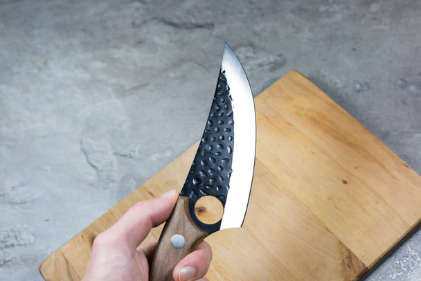 Man hold Big kitchen knife with wooden handle. - Fotó, kép