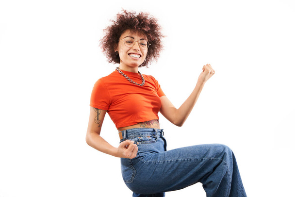 Positive lucky kazakh girl with afro hairstyle laughing rejoices celebrating victory, heard good news isolated on white background - Fotó, kép