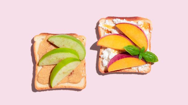 Set of toasted bread with peach and apple on pink background. High quality photo - Foto, afbeelding