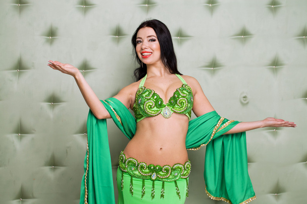 Young pretty woman in green indian dress - 写真・画像
