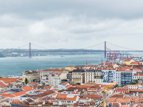 Lisboa, Portugal. April 9, 2022: Panoramic landscape and the Tagus River with a view of the 25 de Noviembre bridge. - Foto, Imagen