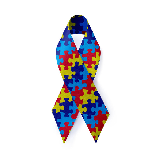 World Autism Awareness Day. Colorful puzzle ribbon on white background, top view - Foto, imagen