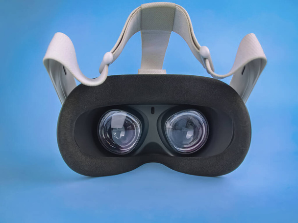 Modern virtual reality headset on light blue background - Foto, imagen
