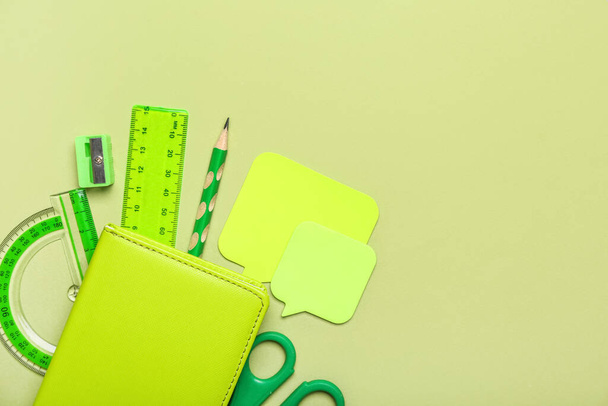 School stationery on green background, top view - 写真・画像