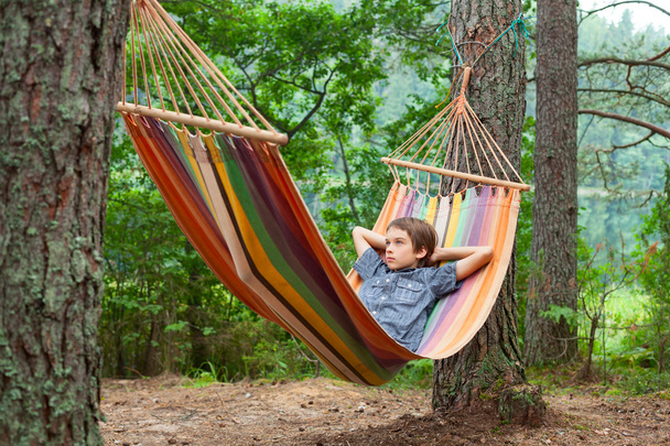 Child relaxing in hammock outdoors - Fotoğraf, Görsel