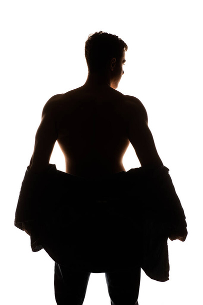 Studio body shot of an attractive man posing shirtless in black denim pants - Foto, Bild