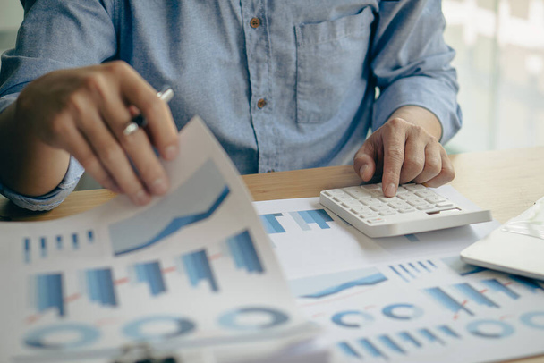The company's accountant analyzes the expenses on the business desk. financial reporting accountant computer with graph chart business idea Finance and Accounting - 写真・画像