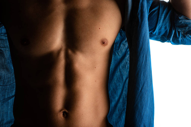 Attractive and handsome guy is posing with his torso, close up - Zdjęcie, obraz