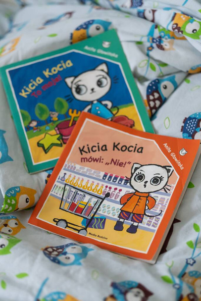 Two Kicia Kocia child books by Polish author Anita Glowinska on a bedsheet - Фото, изображение