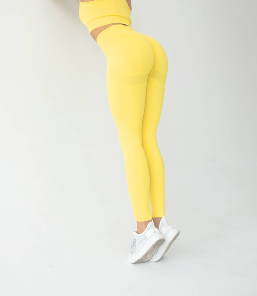 young fit african american woman in sportswear posing on grey background  - Photo, Image
