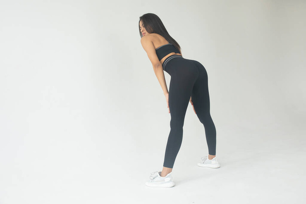 young fit african american woman in sportswear posing on grey background  - 写真・画像