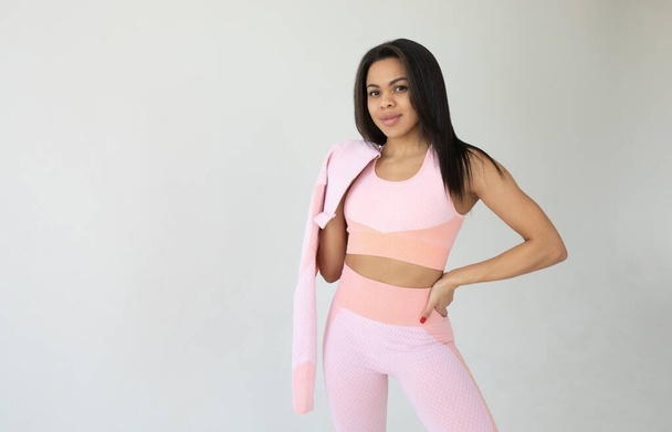 young fit african american woman in sportswear posing on grey background  - Foto, Imagem