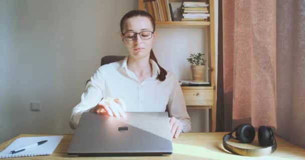 Young woman opens laptop starts working. Front view, portrait, desktop. Concept of secretary, office worker, student, freelancing, remote work from home, home office. High quality 4k footage - Video