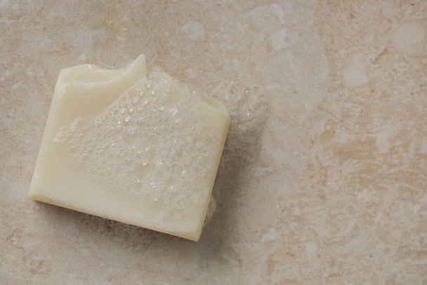 Natural bar soap for healthy skin and hair.Hydrating cleansing bar on stone textured plain background. - Foto, immagini