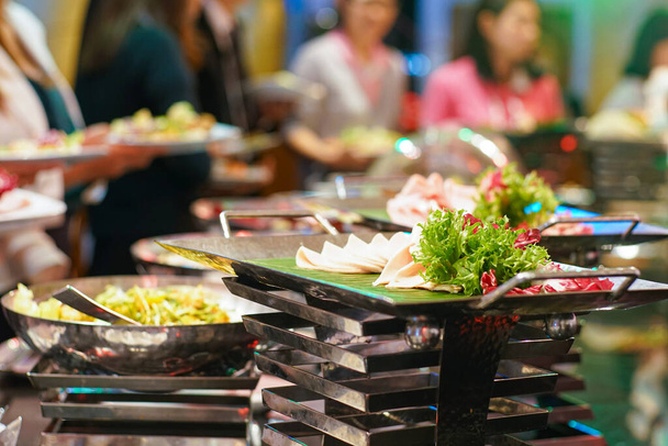 People group grab buffet food in restaurant after seminar - Foto, imagen