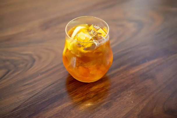 A Glass of Oolong Green Tea with Fresh Mango and Ice Cubes on a  - Fotografie, Obrázek