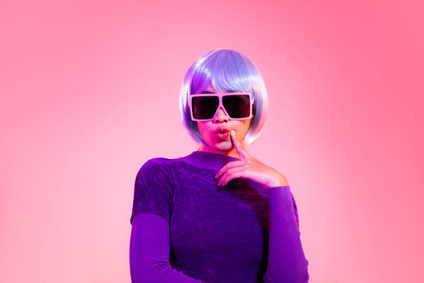 Cyber punk girl concept, asian woman in purple sweatshirt silver and blue short hair style wearing sunglasses posing like robot. - Foto, Imagen