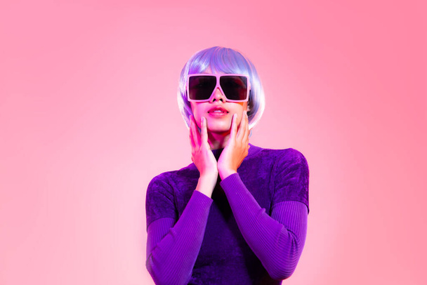 Cyber punk girl concept, asian woman in purple sweatshirt silver and blue short hair style wearing sunglasses posing like robot. - Foto, Imagem