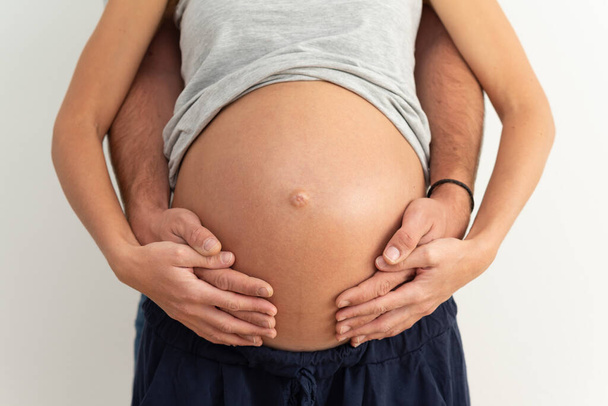 New parents expecting a baby and embracing the pregnant belly.  - Photo, image