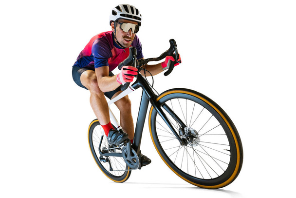 Portrait of man, professional cyclist training, riding isolated over white studio background. Concentration. Concept of sport, action, motion, speed, hobby, lifestyle. Copy space for ad - Foto, Imagen