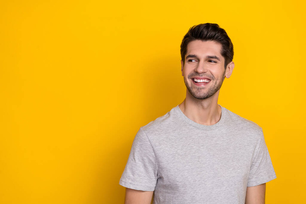 Photo of good brunet millennial guy look promo wear trend cloth isolated on yellow color background. - Photo, image