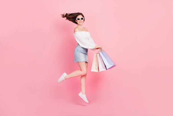 Full size photo of charming adorable female shopaholic buy many stylish clothes isolated on pink color background. - Valokuva, kuva
