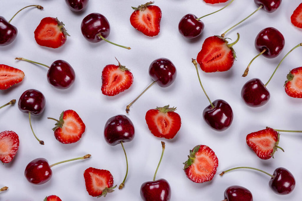  background of ripe strawberries and cherries on a white background. Trendy,fruity,summer loop background. - Fotó, kép