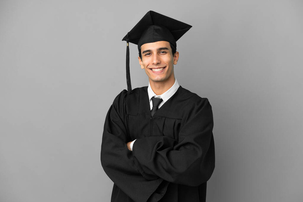 Young Argentinian university graduate isolated on grey background with arms crossed and looking forward - Φωτογραφία, εικόνα