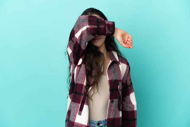 Young caucasian woman isolated on blue background covering eyes by hands - Photo, Image