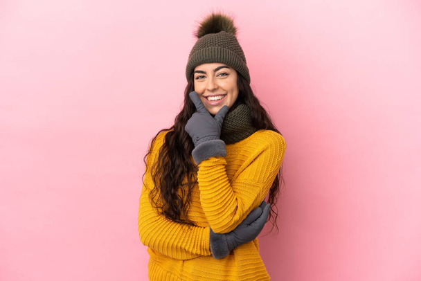 Young caucasian girl with winter hat isolated on purple background happy and smiling - Foto, immagini